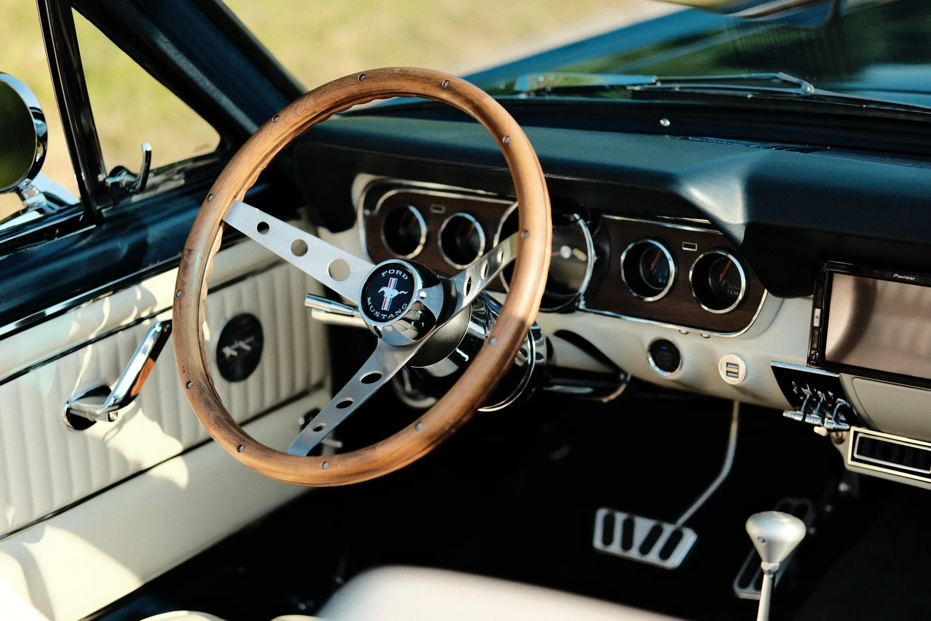Interior view from driver side, wood wheel and gauges